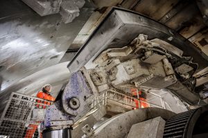 A-concrete-tunnel-ring-segment-is-moved-into-place-by-TBM-Sushila-to-create-HS2s-Northolt-Tunnel-300x200.jpg