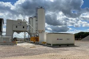 A photo of the Alrewas plant showing Cemex branded facilities including a shipping container in the foreground and bare ground around it