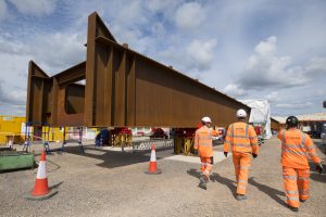 EKFB-staff-pass-the-first-Wendover-Dean-steel-beam-on-site-June-2023-300x200.jpg